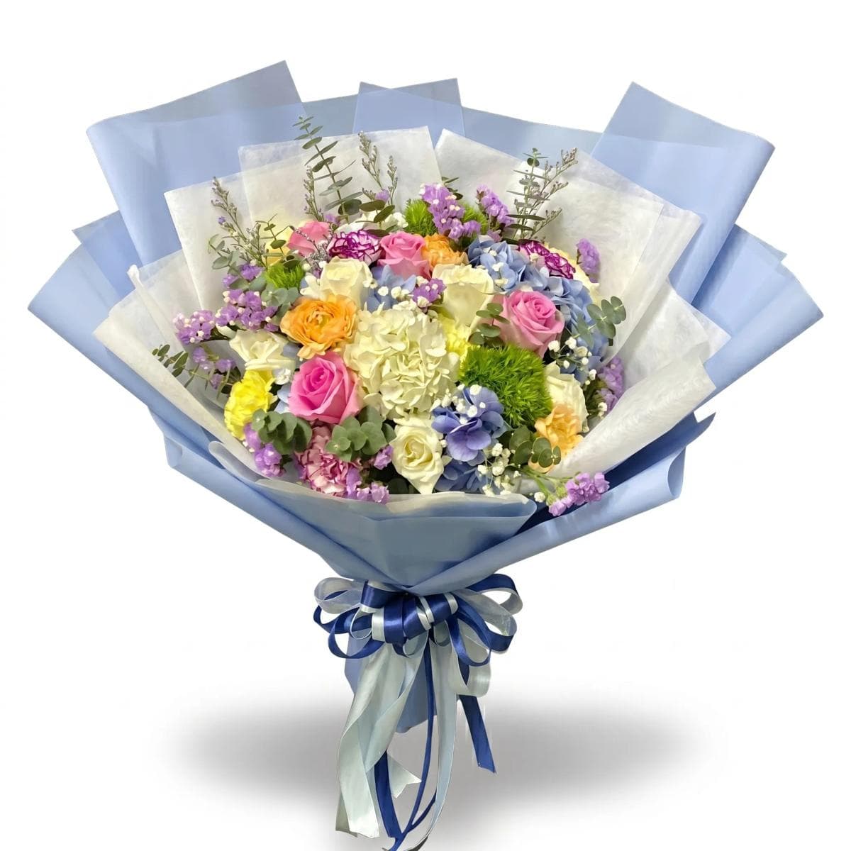 A soft mixed bouquet in white and pastel tones — thoughtfully arranged with seasonal blooms and light greenery for a clean, elegant look. Flower types may vary based on daily availability, while the overall style and color palette stay the same.