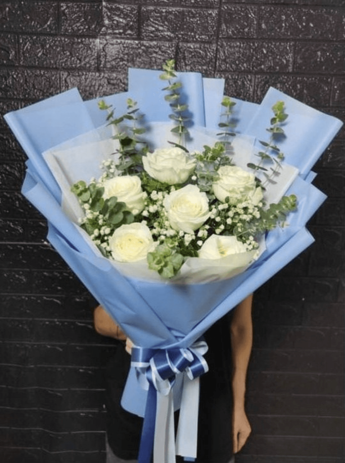 A soft, romantic bouquet featuring fresh roses surrounded by delicate filler flowers and seasonal greenery, arranged in a full, rounded shape. Finished with quality wrapping and a ribbon, it’s a timeless choice for birthdays, anniversaries, congratulations, or a gentle “thinking of you.”