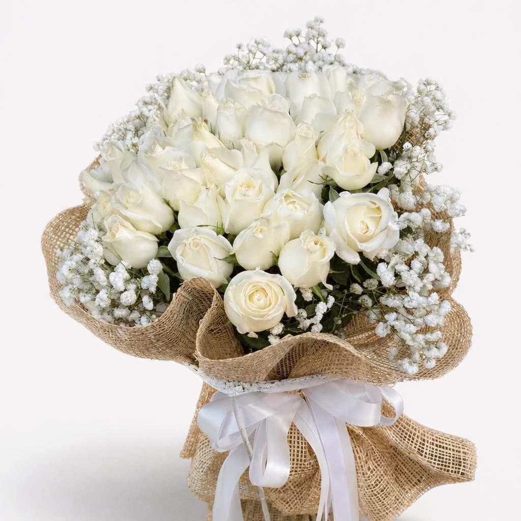 Elegant white rose bouquet wrapped in burlap.