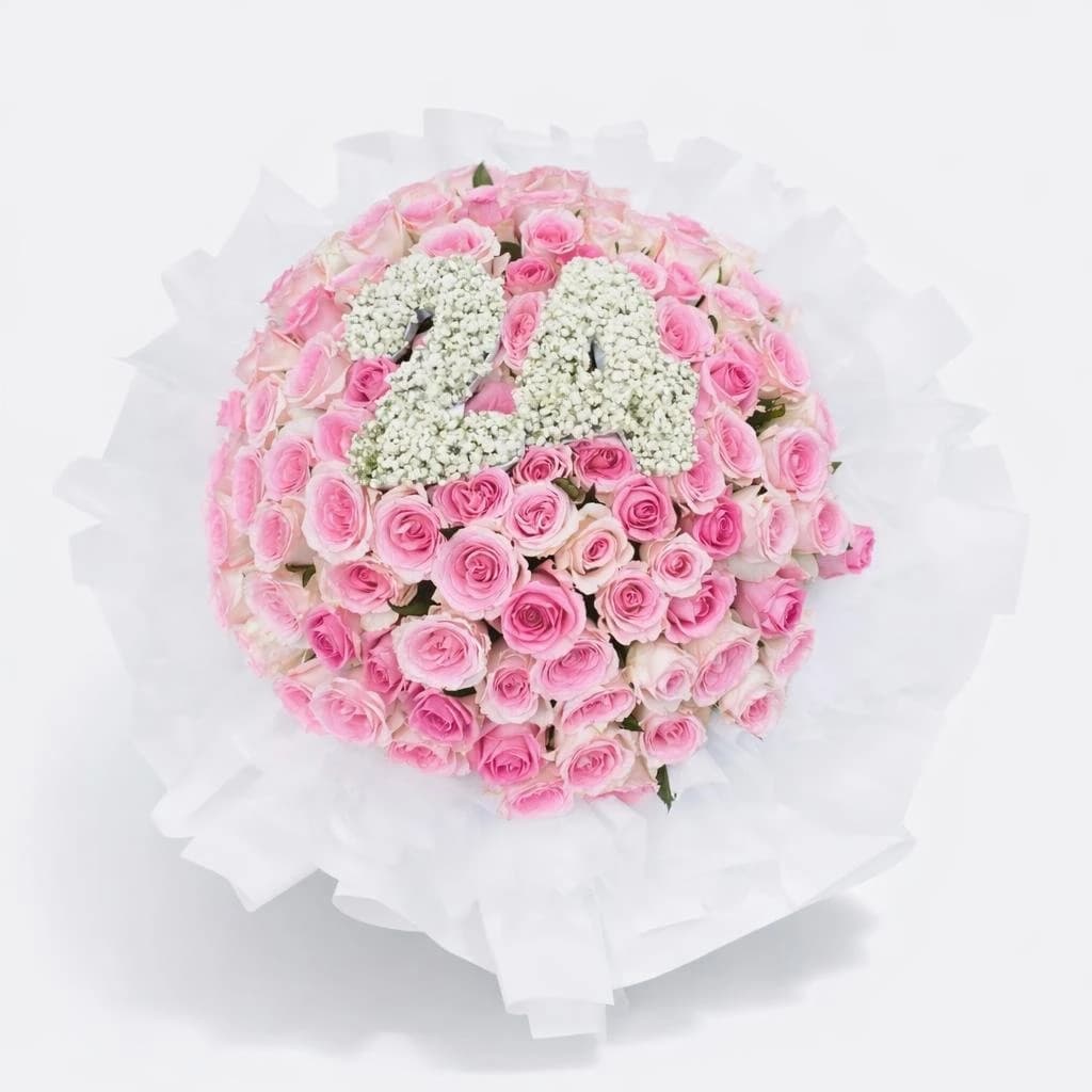 Pink bouquet of roses and baby's breath wrapped in white for birthday celebrations with number made from baby’s breath flower