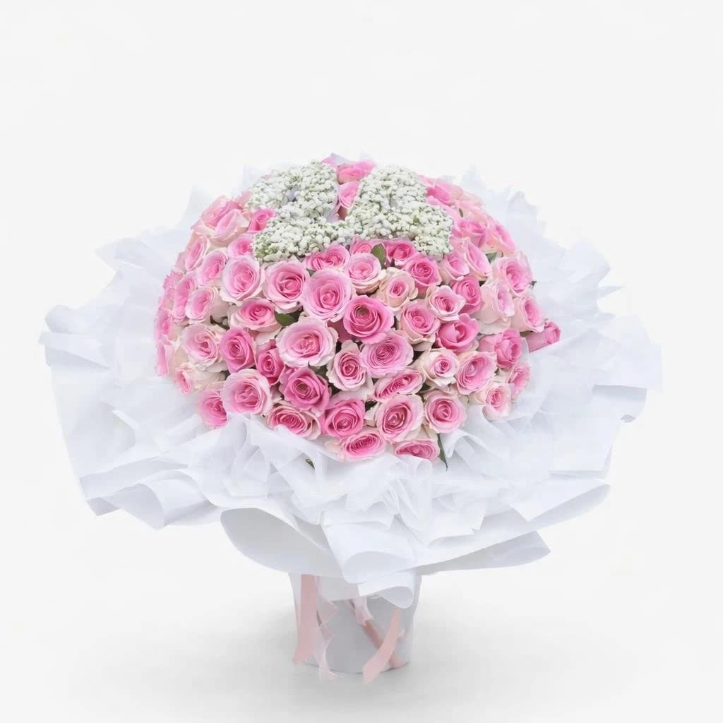 Pink bouquet of roses and baby's breath wrapped in white for birthday celebrations with number made from baby’s breath flower