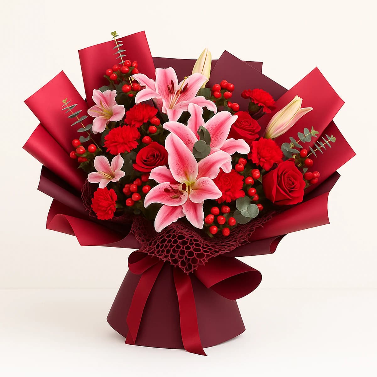 Romantic Elegance Bouquet | Pink Lilies & Red Roses ประกอบด้วย กุหลาบแดง, ลิลลี่สีชมพู, การ์เนชั่น, ยูคาลิปตัส, ผักชี,